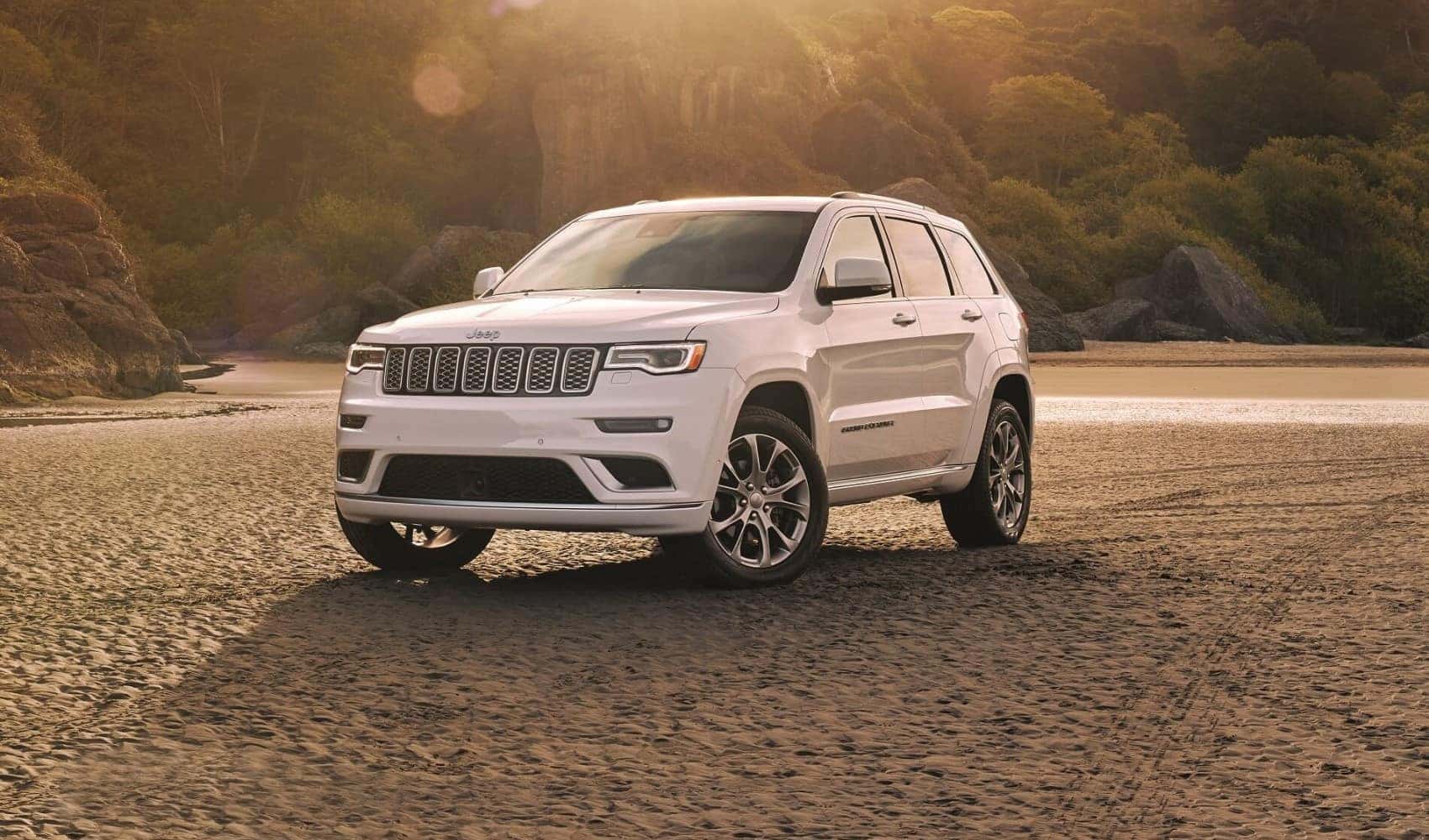 2021 Jeep Grand Cherokee white parked in wooded area