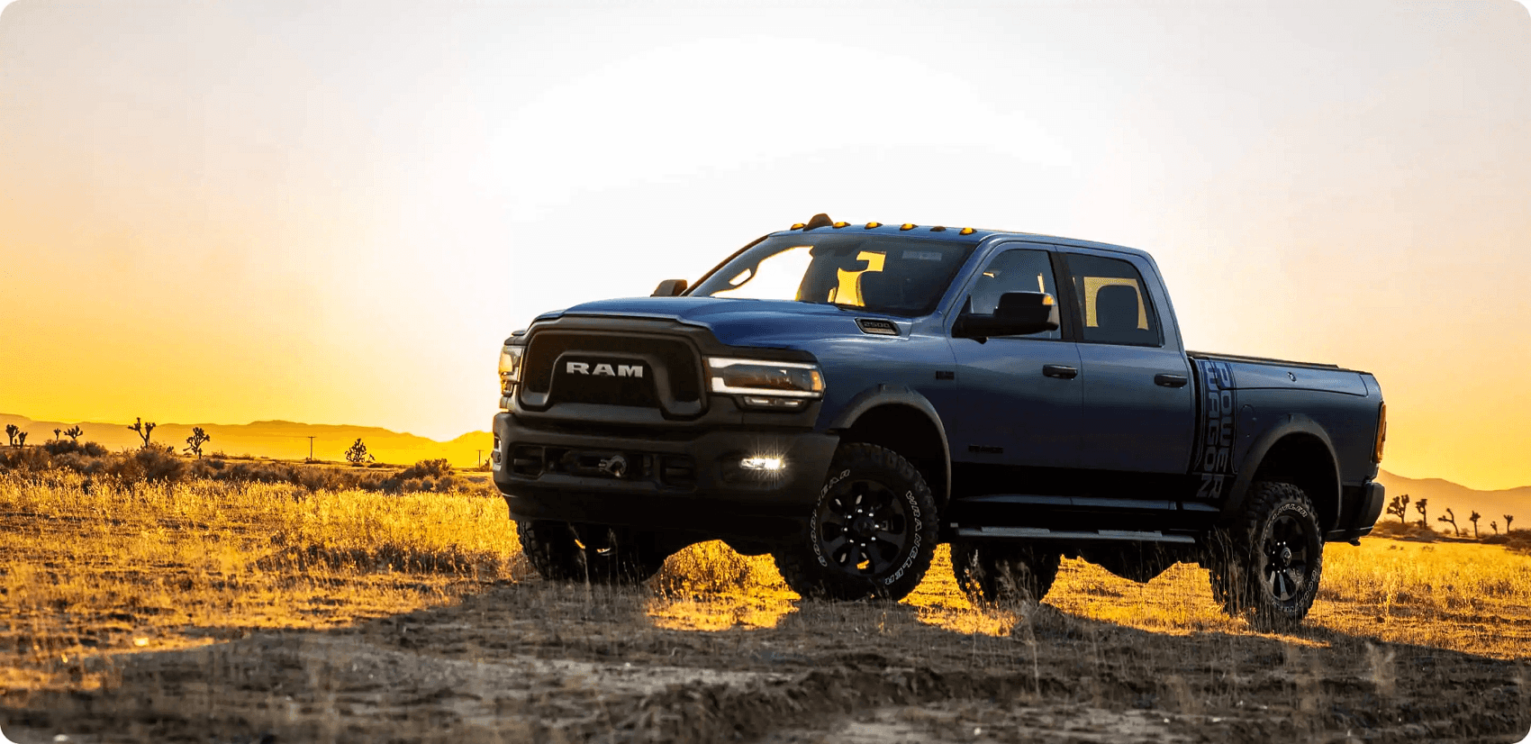 Ram 2500 parked in field at sunset from Ram Dealer Clinton Township MI