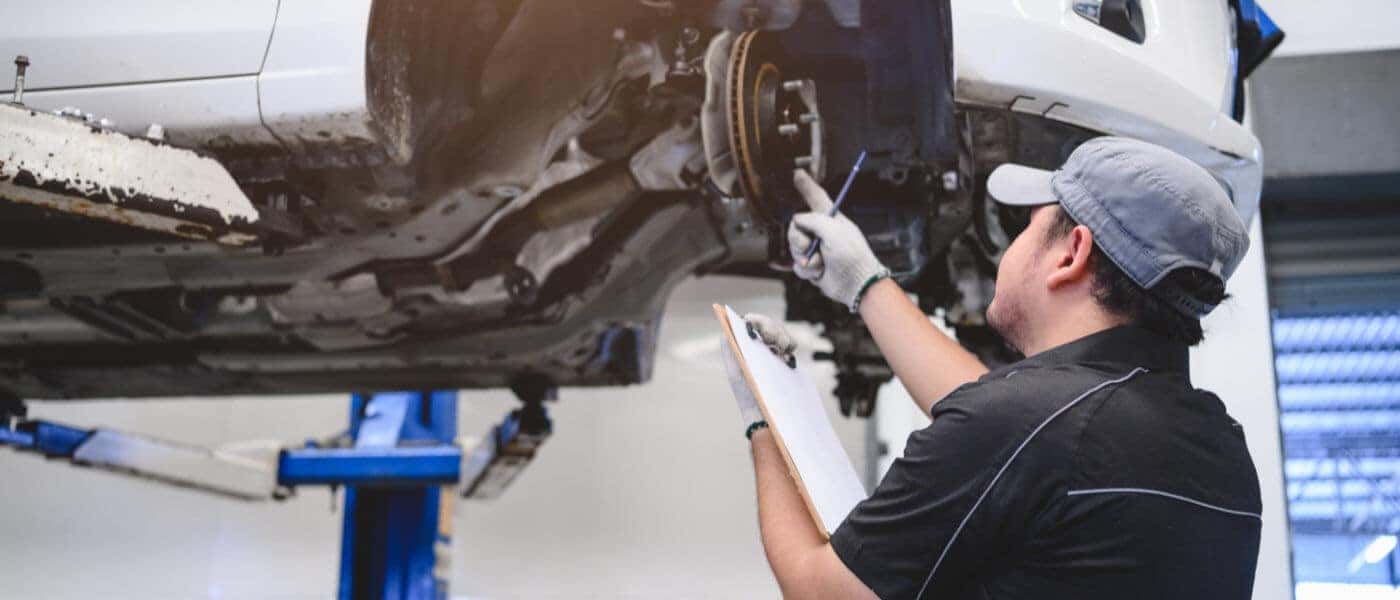Service technician inspecting brakes