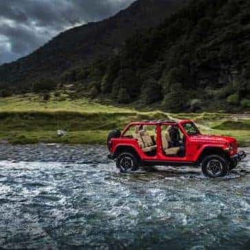 2018 Jeep Wrangler 4-door driving through the water
