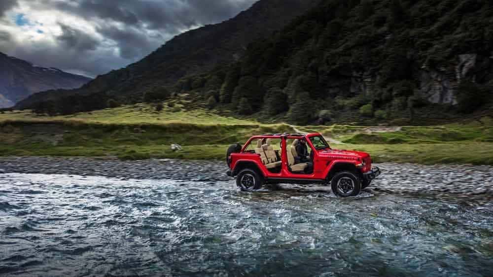 2018 Jeep Wrangler 4-door driving through the water