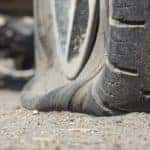 Flat tire on the side of the road