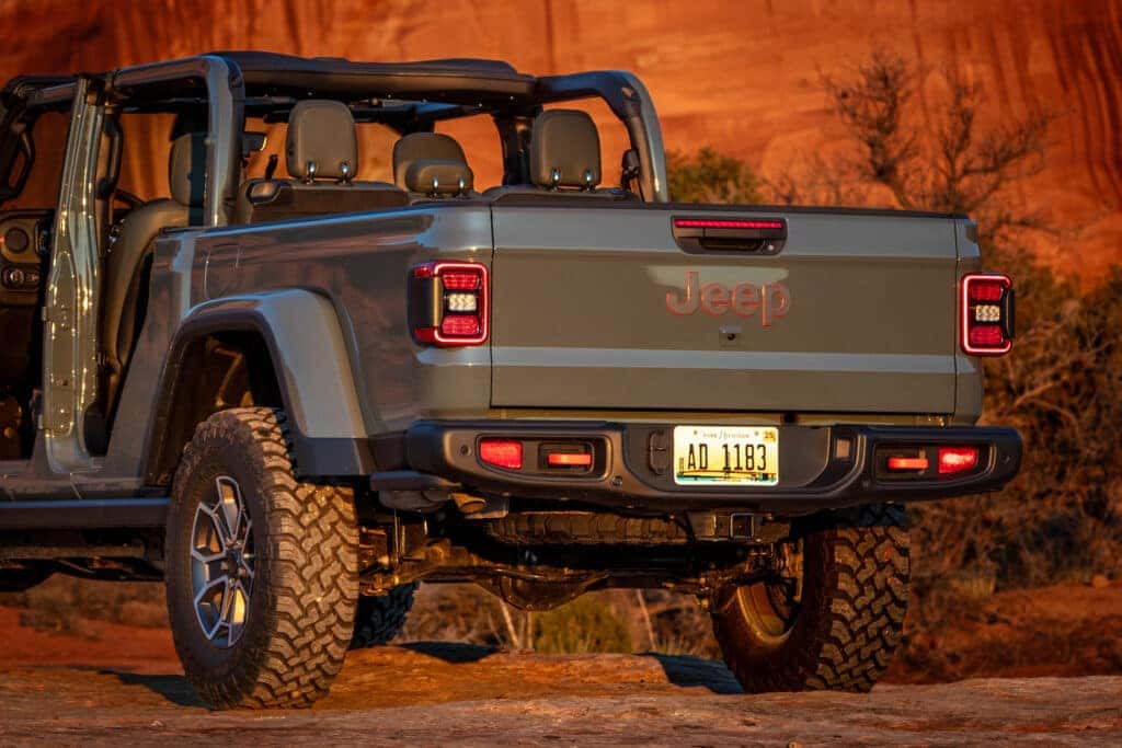 A rear view of a gray 2025 Jeep Gladiator in the desert.