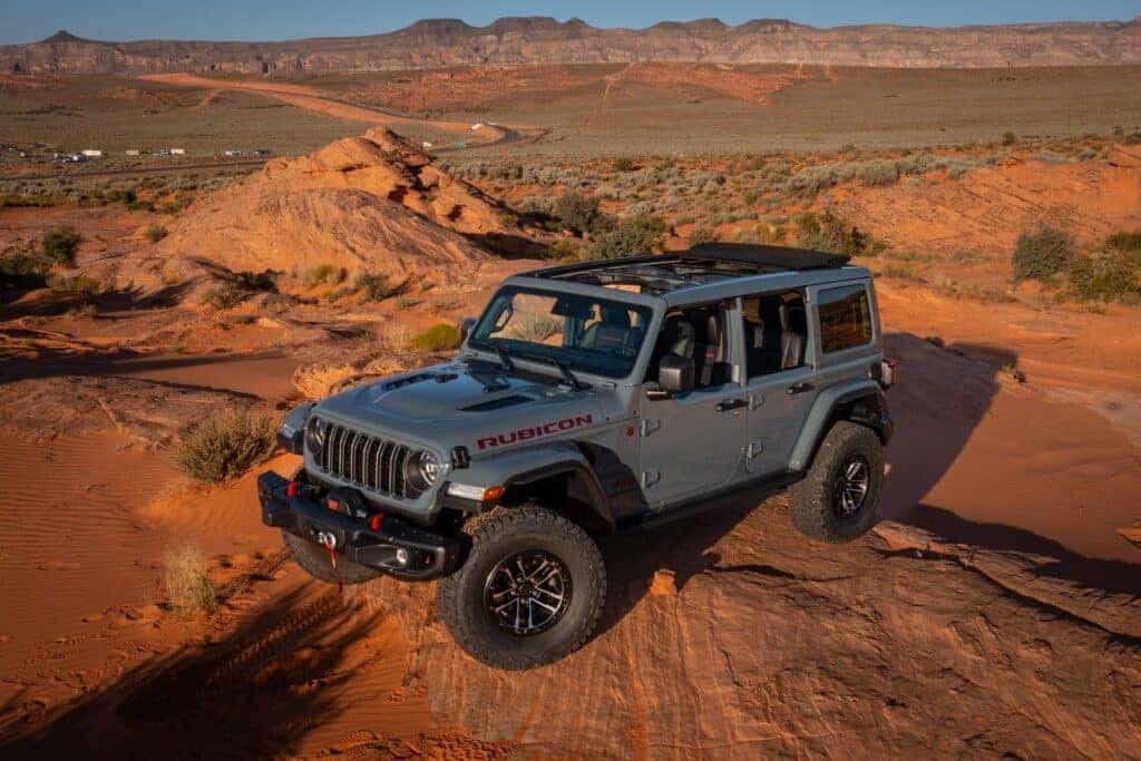 2025 Jeep Wrangler on red rocks in the desert.