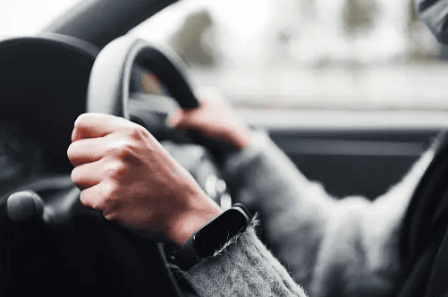 driver holding steering wheel