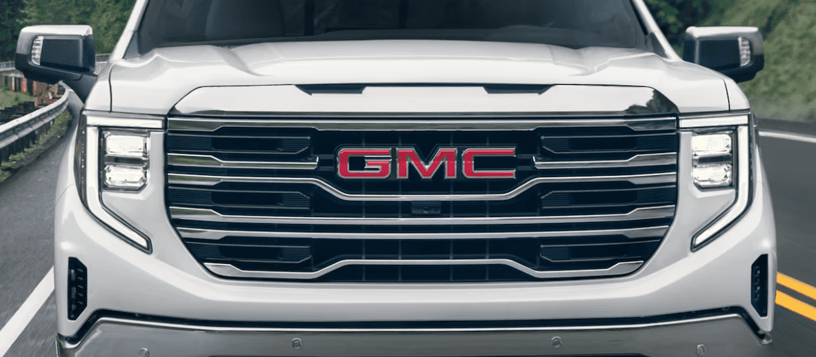 The front grille of a white 2024 GMC Sierra 1500