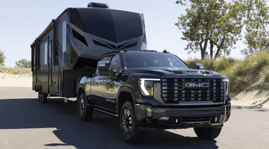 A black GMC Sierra HD with a black trailer attached