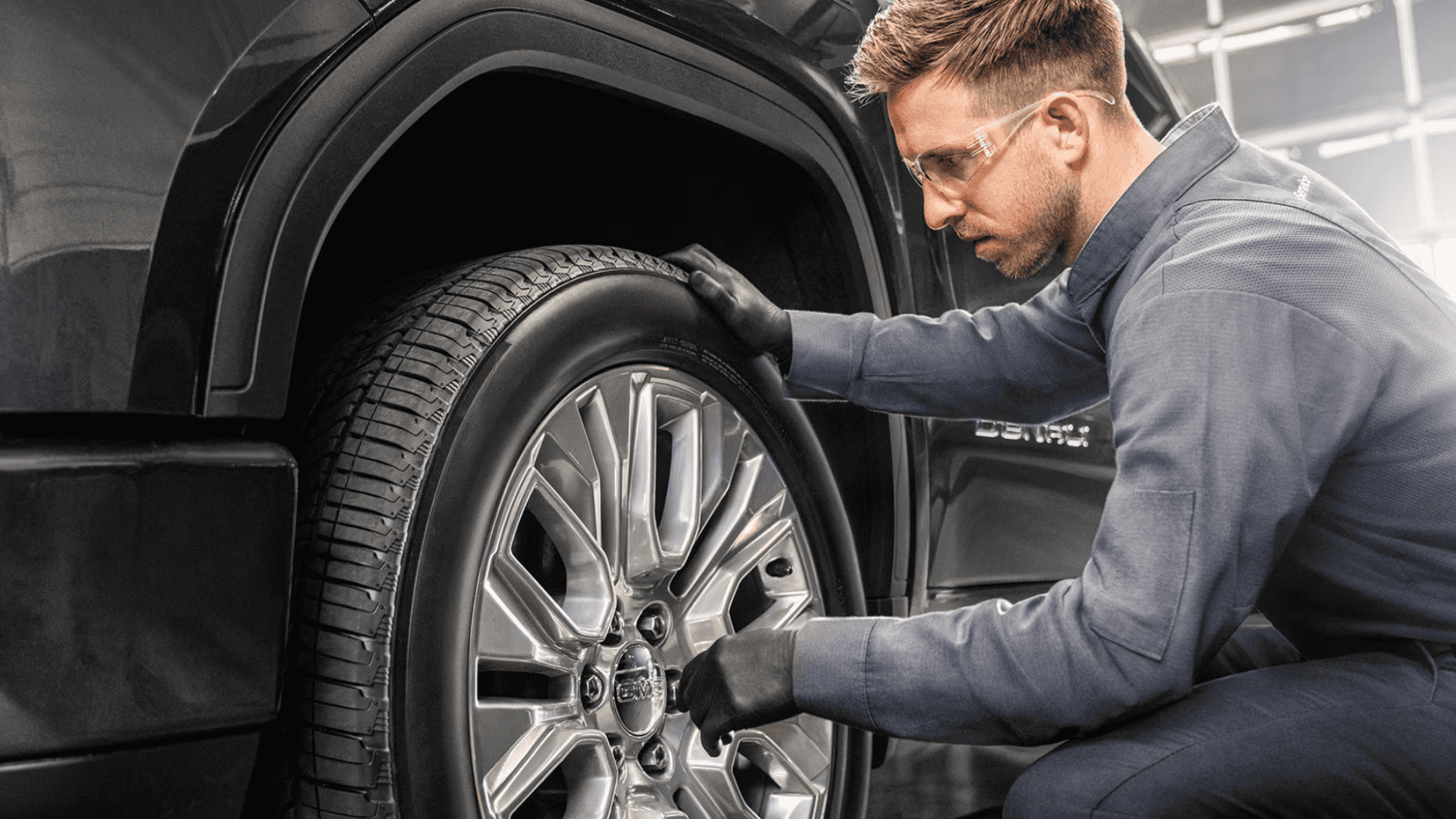 GMC Technician replacing a tire