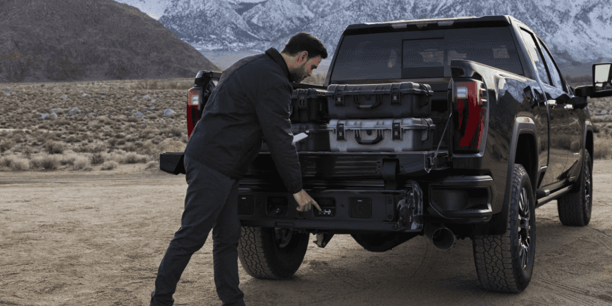 2024 GMC Sierra truck bed being opened by the driver