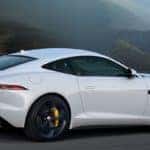 The 2020 F-TYPE R in Yulong White with yellow brake calipers driving on mountain highway