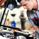 Toyota mechanic checking the oil level on a dipstick.