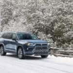 Toyota SUV driving on snowy road.