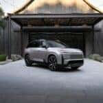 silver Highlander quartering toward in front of building