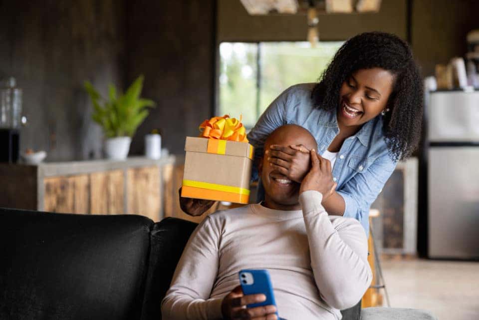 Woman surprising dad with Father's Day gift.