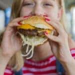 Woman eating beef burger
