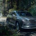 Mazda SUV on wooded road