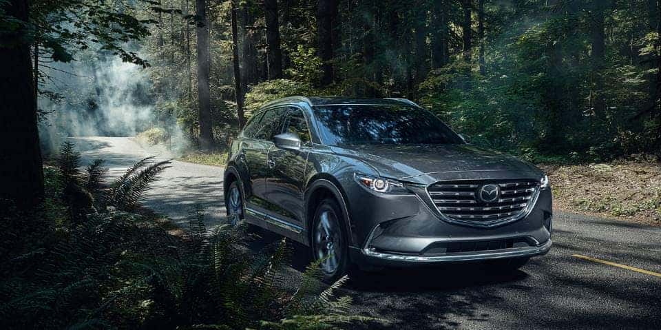 Mazda SUV on wooded road