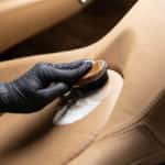 Cleaning leather car seat and upholstery with brush