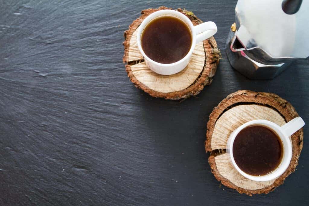Coffee cups on wooden coasters