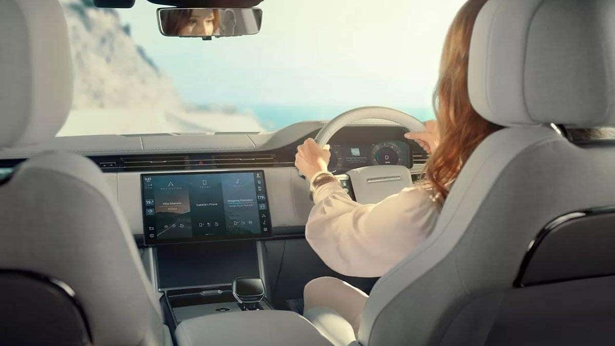 Interior view of a 2026 Land Rover Range Rover being driven along a coastal road