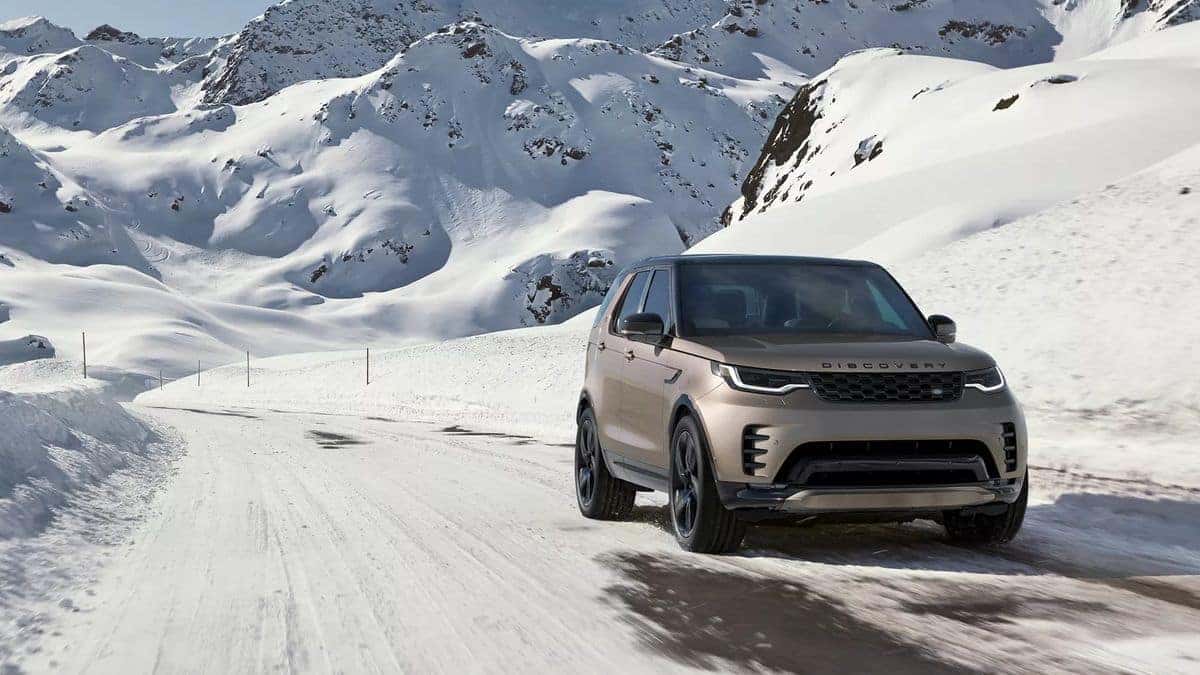 2026 Land Rover Discovery driving on a snowy mountain road