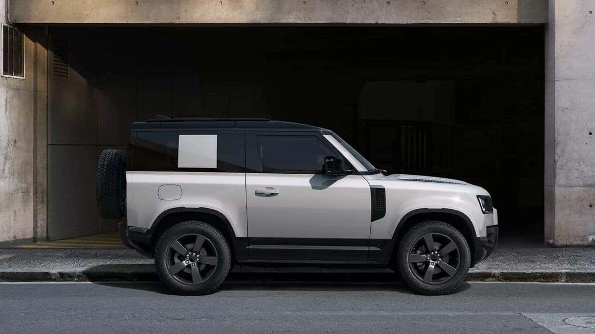 2026 Land Rover Defender 90 exterior parked outside a city garage