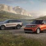 three different land rover models parked in a mountain glen