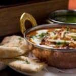 indian food in brass bowl
