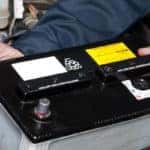 closeup of technician replacing car battery