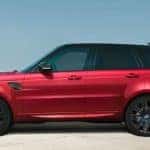 2019 Range Rover Sport Autobiography Dynamic in Firenze Red parked in concrete structure next to ocean