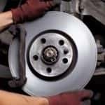 Car mechanic Repairing brakes on car