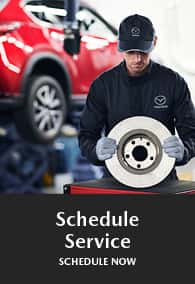 Schedule Service button featuring a Mazda technician and a red vehicle.