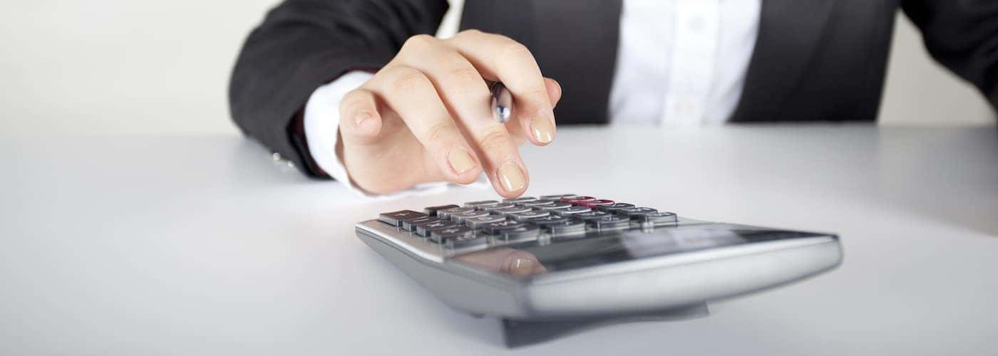 womans hands tapping calculator