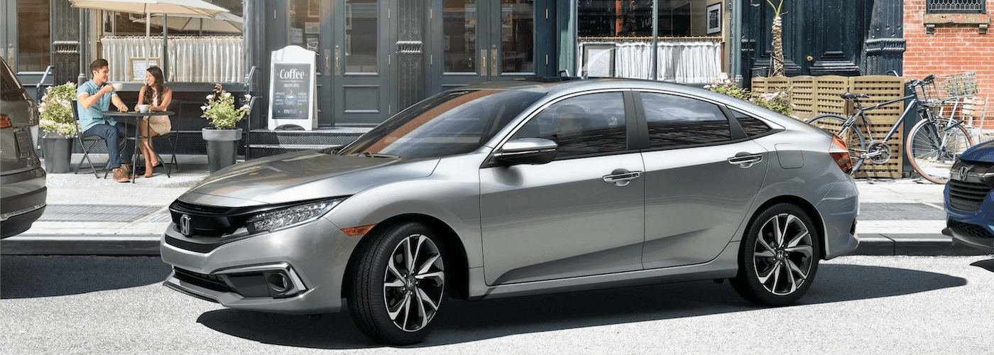 2020 honda civic silver exterior pulling out of the parking lot