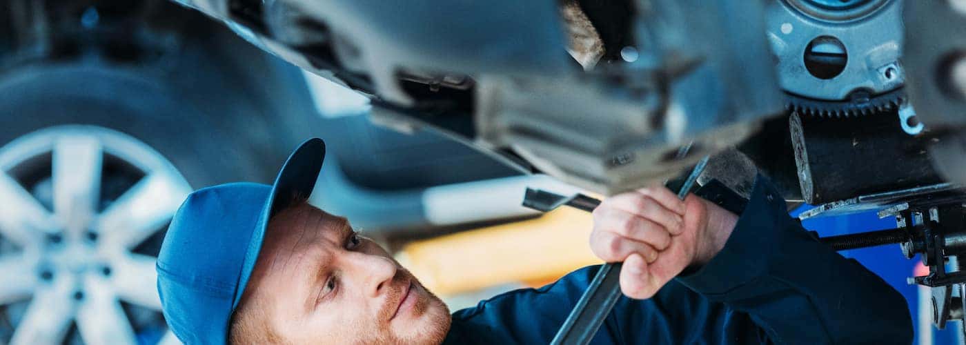 car mechanic working under car close up