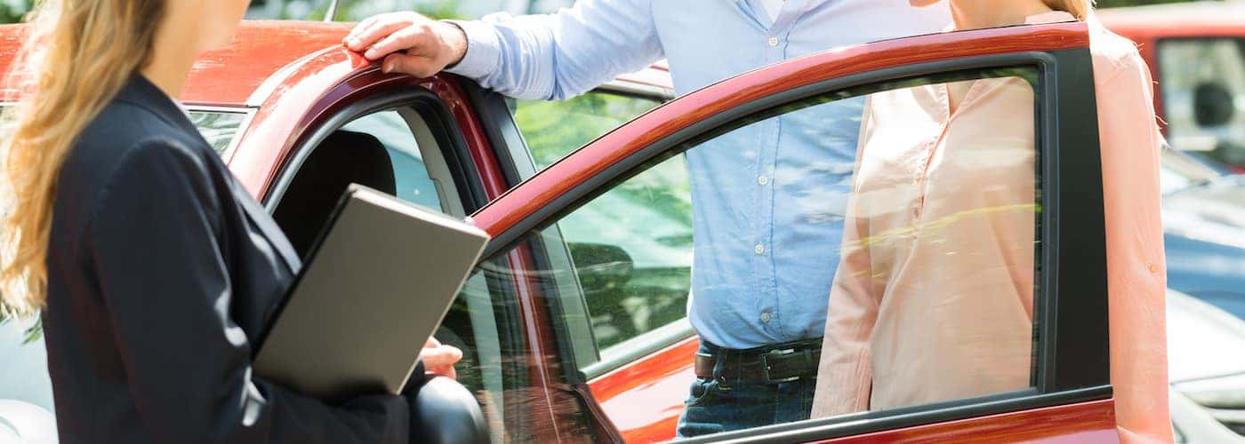 couple looking at new car