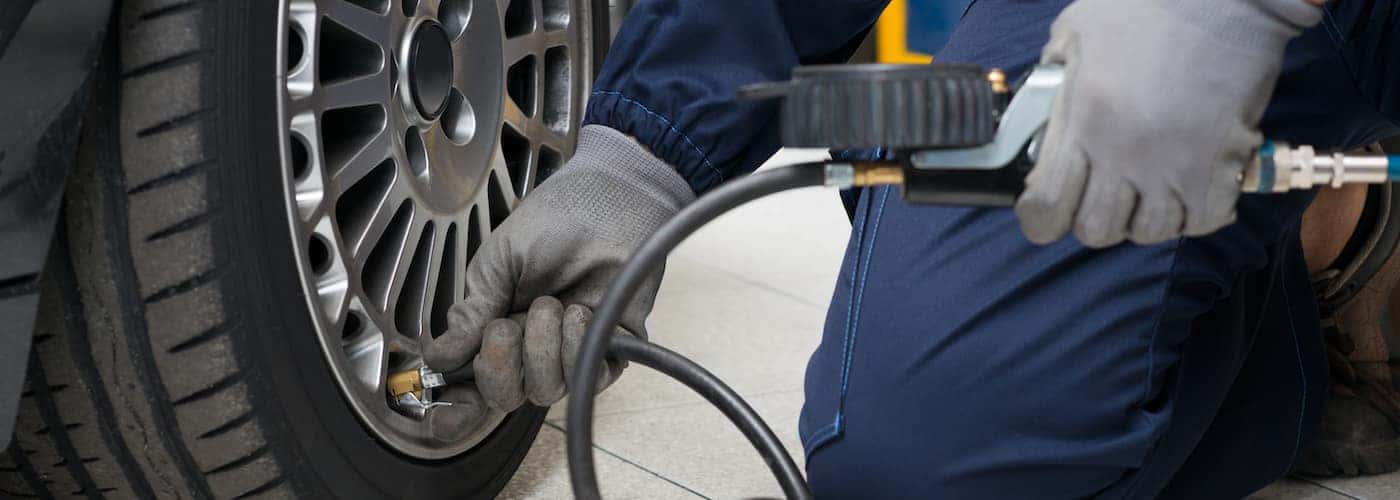 mechanic checking tire pressure