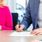 Couple signing a sales contract