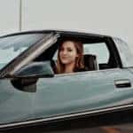 Young girl sitting in sports car