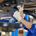 auto mechanic at car suspension repair work