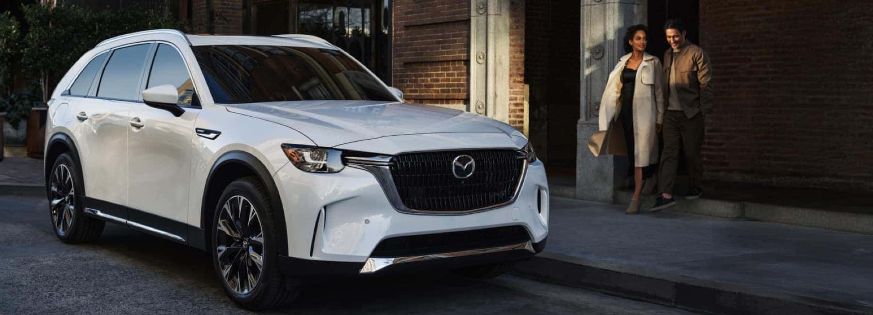 2026-CX-90-parked-at-city-curb-with-couple