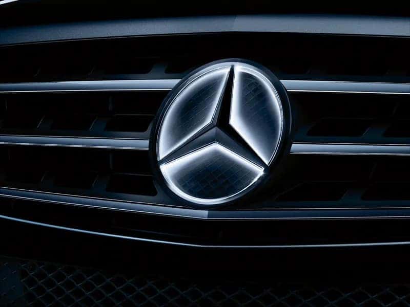 Up close view of the logo on a Mercedes-Benz sedan