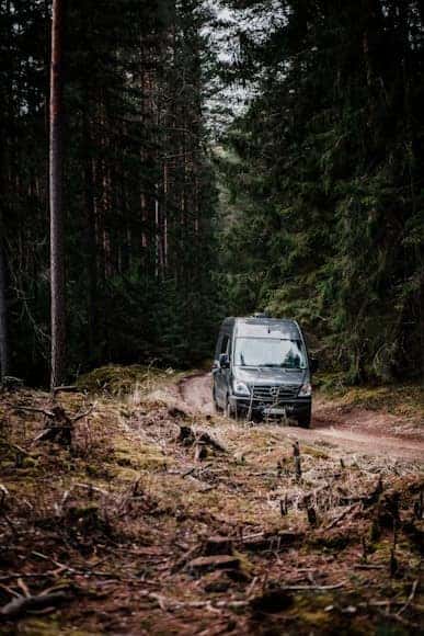 Mercedes-Benz sprinter van traveling down a trail road