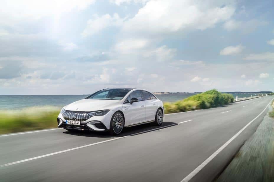 Mercedes-Benz EQE driving down a highway by the ocean