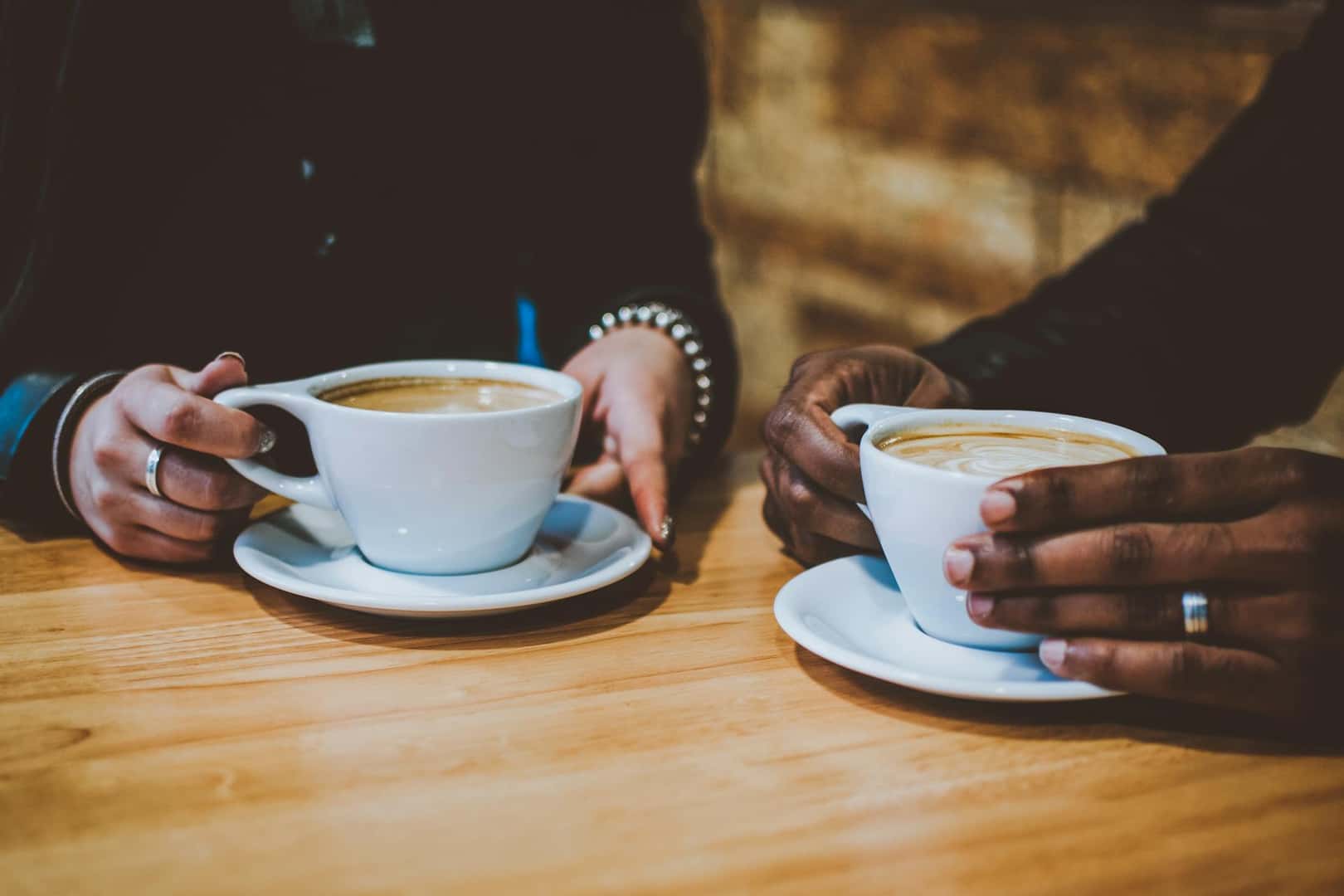 Two people enjoying cups of coffee at a coffee shop