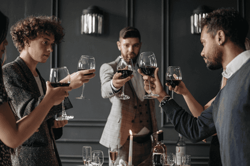 4 men drinking wine in a restaraunt