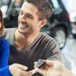 couple getting keys to new car