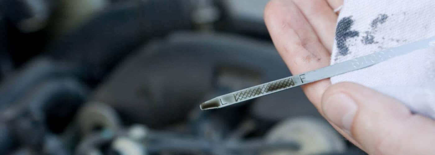 Checking oil level on dipstick