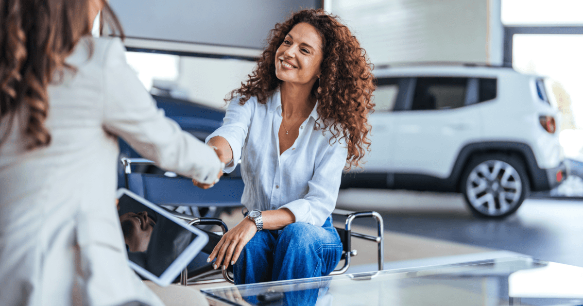 Woman shaking hands with a Mercedes sales associate