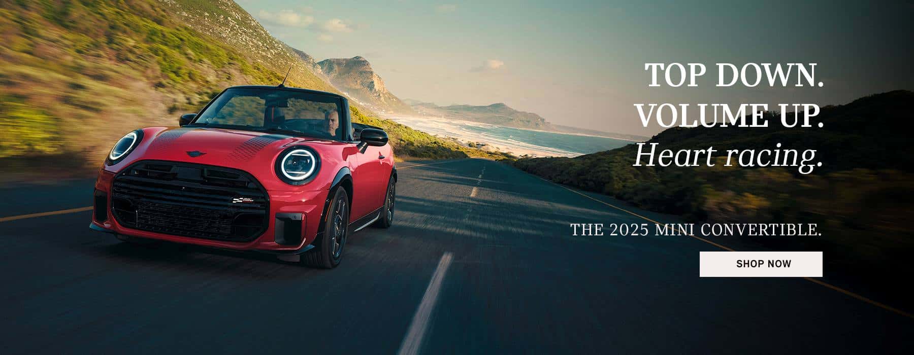 MINI JCW Convertible cruising down a street.